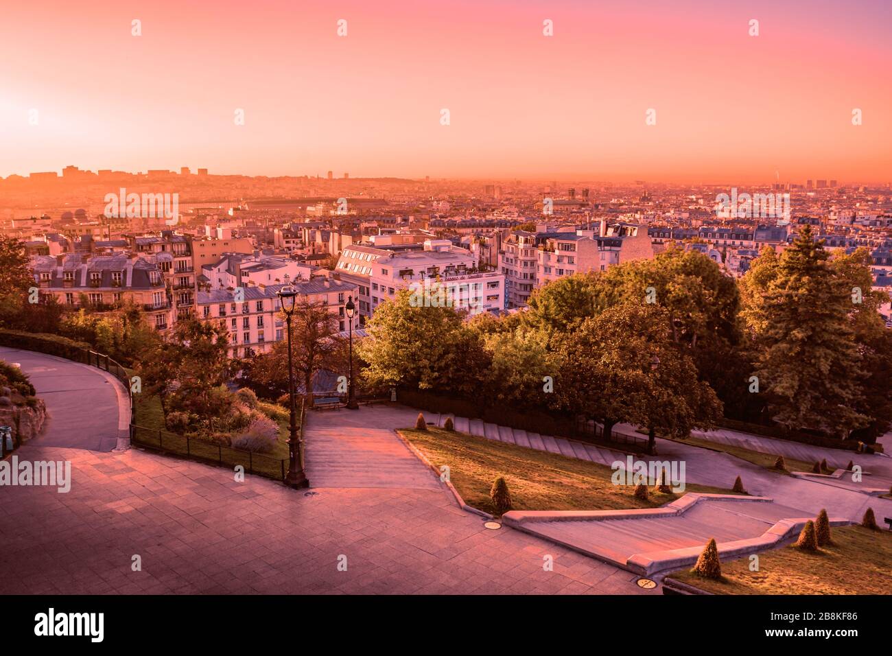 Overlooking the rooftops of Paris during a colorful and vibrant sunrise from Montmartre Hill, Paris, France taken on a warm Autumn morning Stock Photo