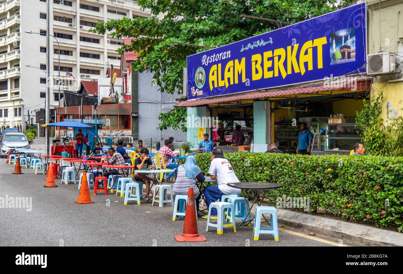 Diners eating outdoors alfresco of restaurant Alam Berkat Jalan Doraisamy street Kuala Lumpur Malaysia. Stock Photo