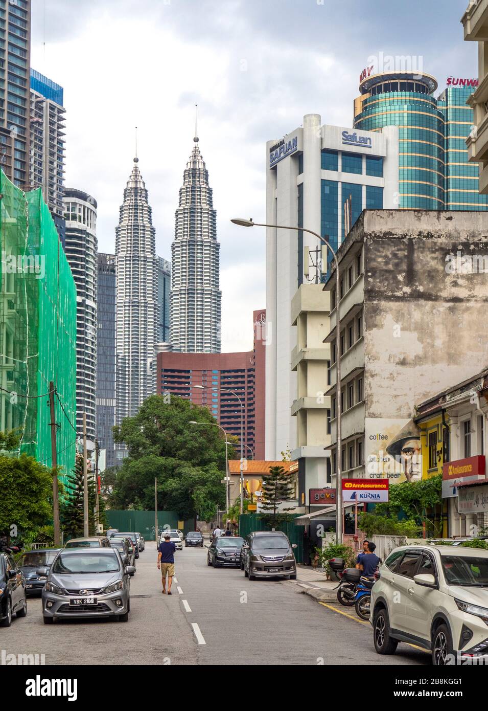 Traffic and pedestrians on Jalan Yap Ah Shak street and Petronas Twin Towers in the background Kuala Lumpur Malaysia. Stock Photo