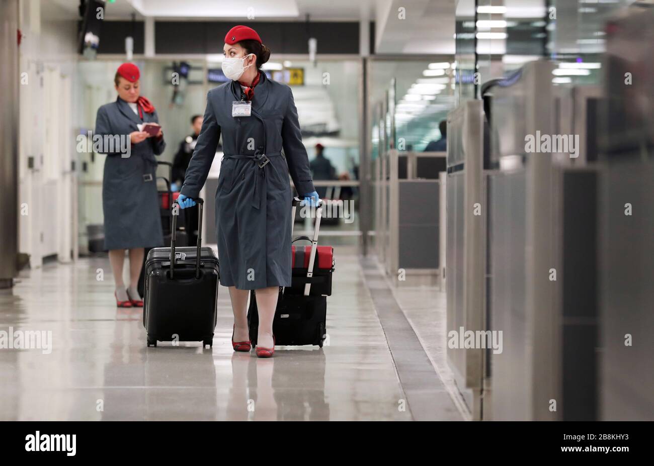 Flight crews arriving at Dulles International Airport wearing personal protective equipment March 13, 2020 in Dulles, Virginia. In response to the COVID-19, coronavirus pandemic CBP officers and travelers have begun wearing gloves and masks as protection from viral exposure. Stock Photo