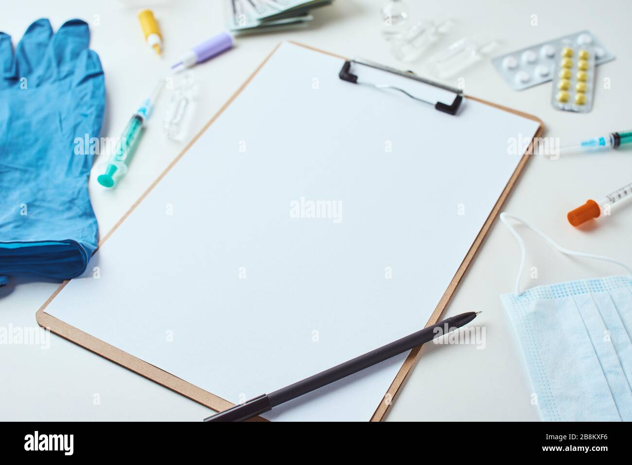 Top view of medical items and empty paper blank sheet on white ...