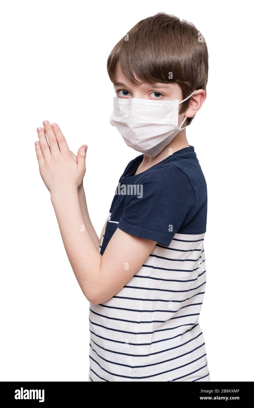 Little boy with face mask praying, isolated on white background Stock