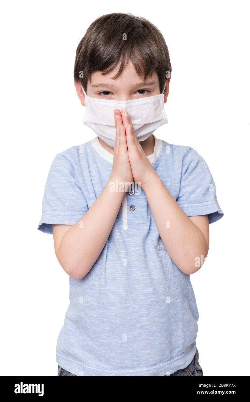 Little boy with face mask praying, isolated on white background Stock