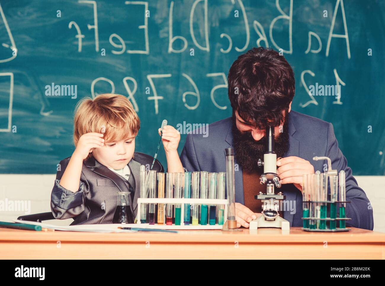 Where Learning Begins. father and son at school. bearded man teacher