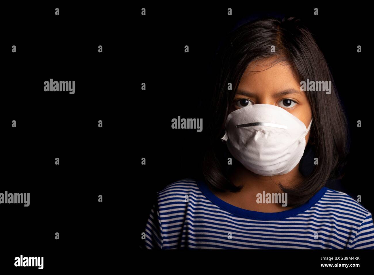 Portrait of little girl wearing a medical mask used for virus ...