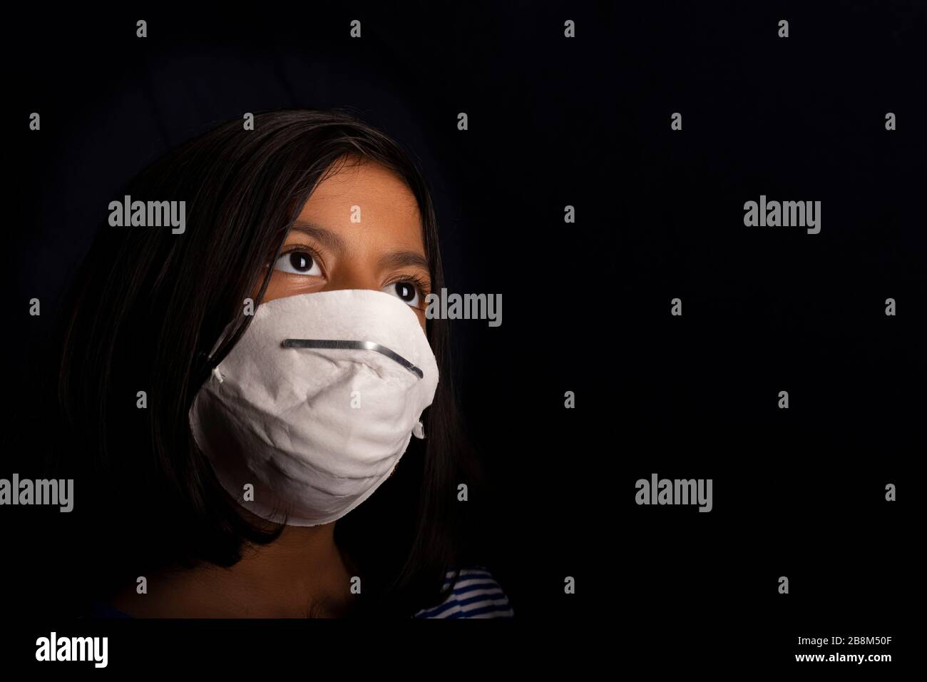 Portrait of little girl wearing a medical mask used for virus ...