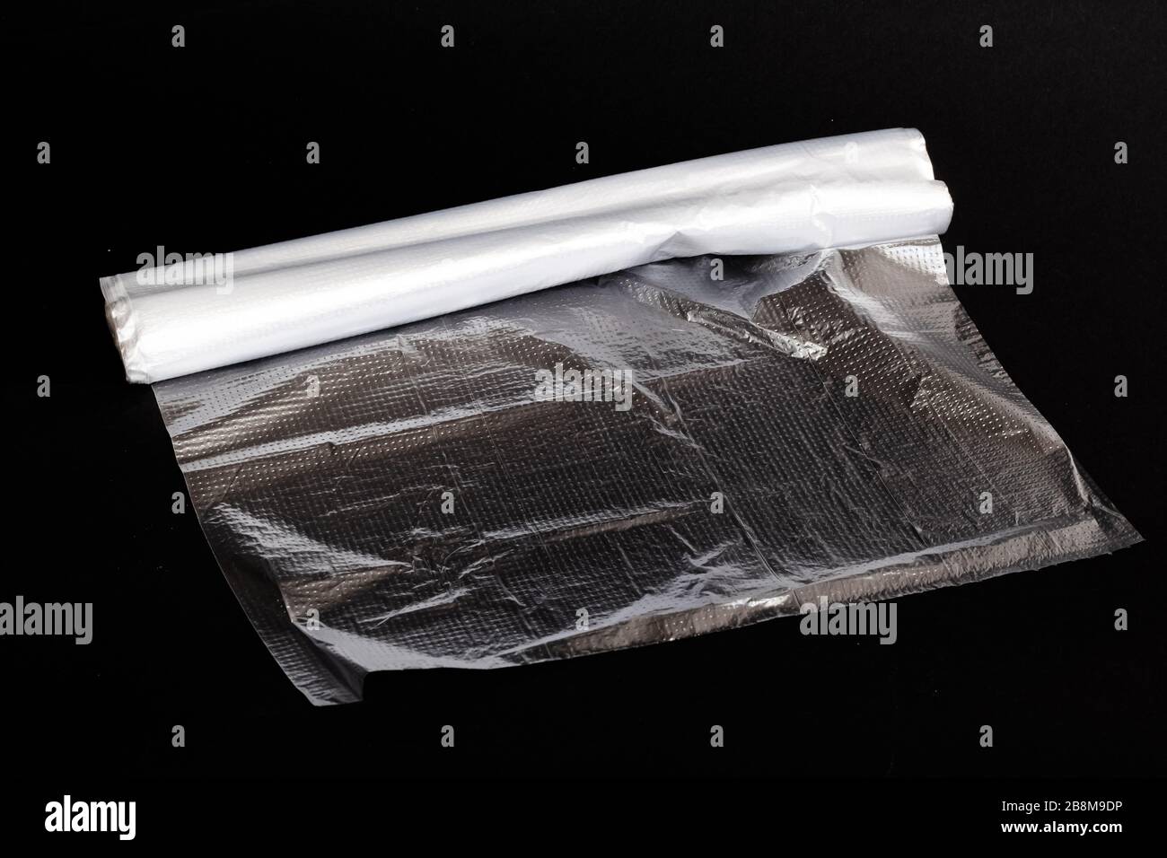 Roll of plastic bags on black background Stock Photo Alamy
