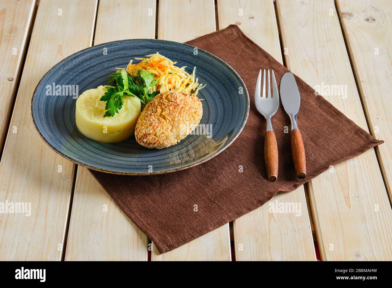 Chicken cutlet in breading with mashed potato and pickled cabbage Stock Photo