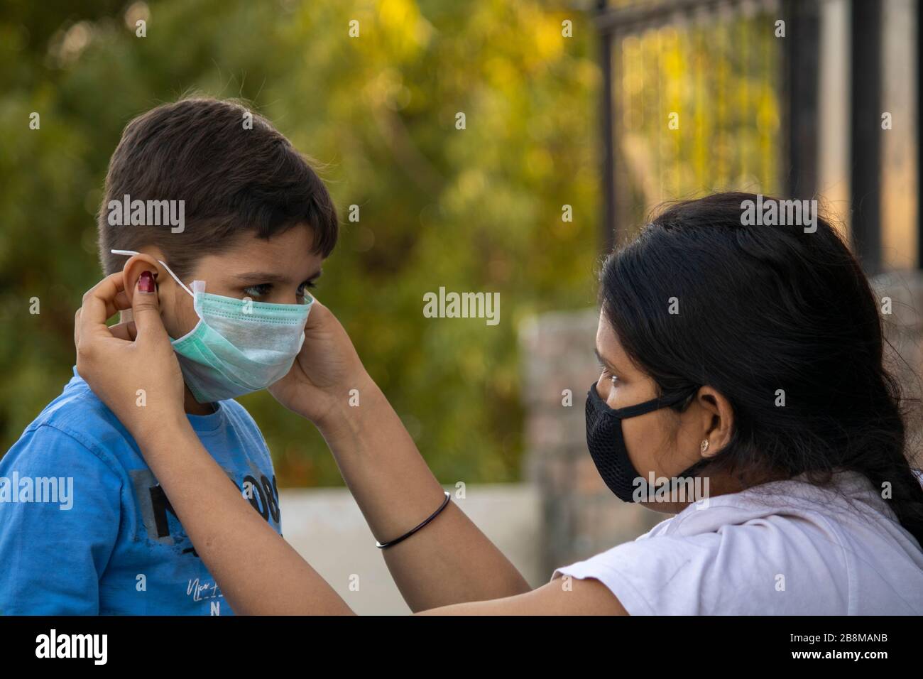 Indian child coughing on his elbow showing tips to protecting corona virus Stock Photo