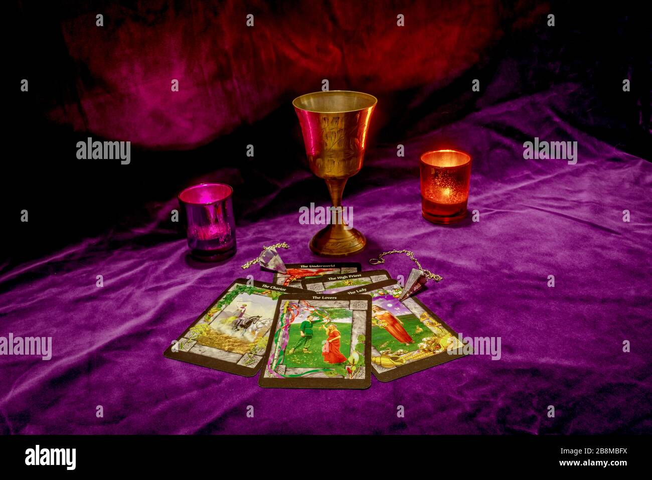 Fortune telling with tarot cards, crystal dowsing pendulums, a brass