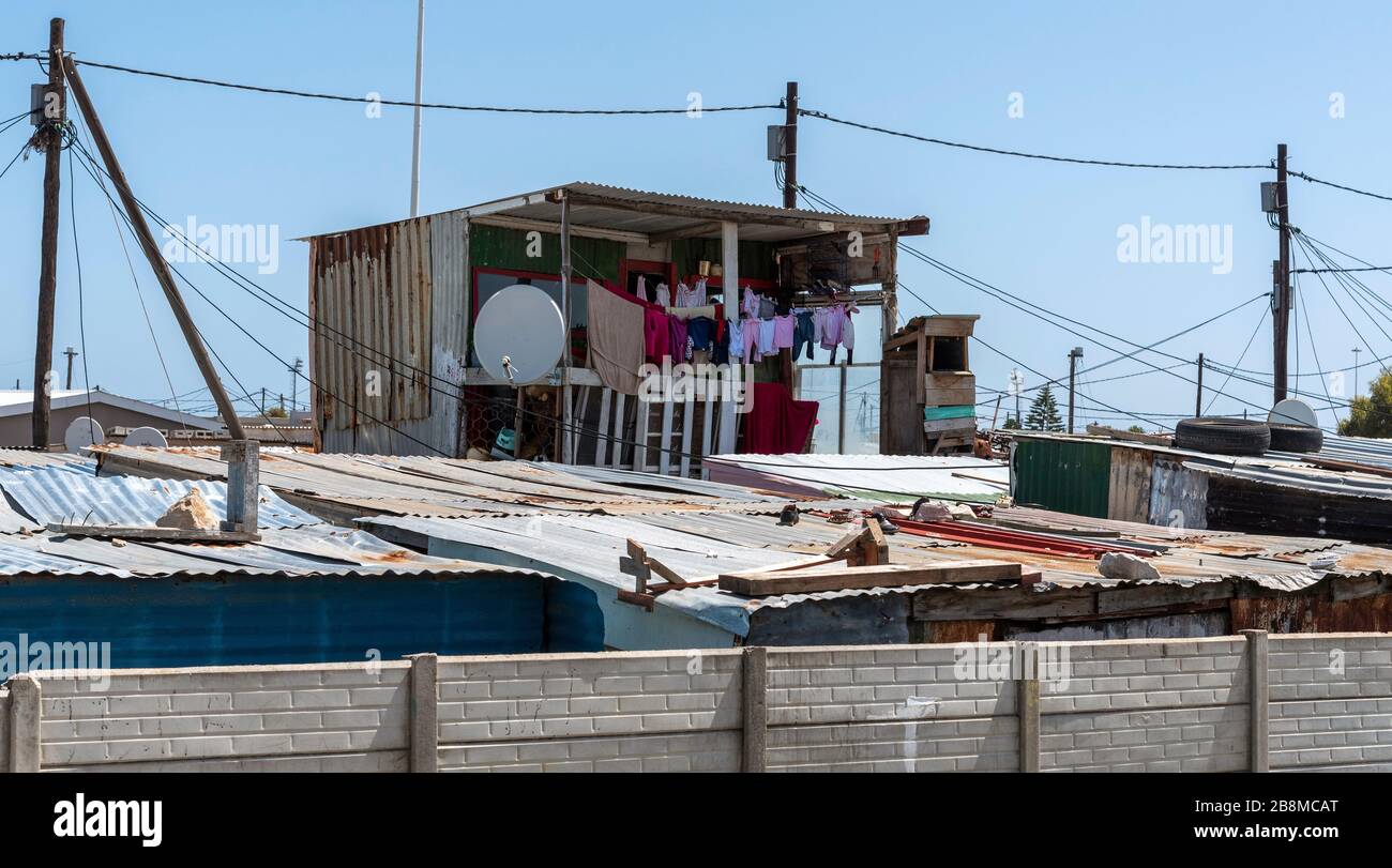 Zwelihle, Hermanus, Western Cape, South Africa.   Two storey shack with clothes drying at Zwelihle township in Hermanus, Western Cape, South Africa Stock Photo