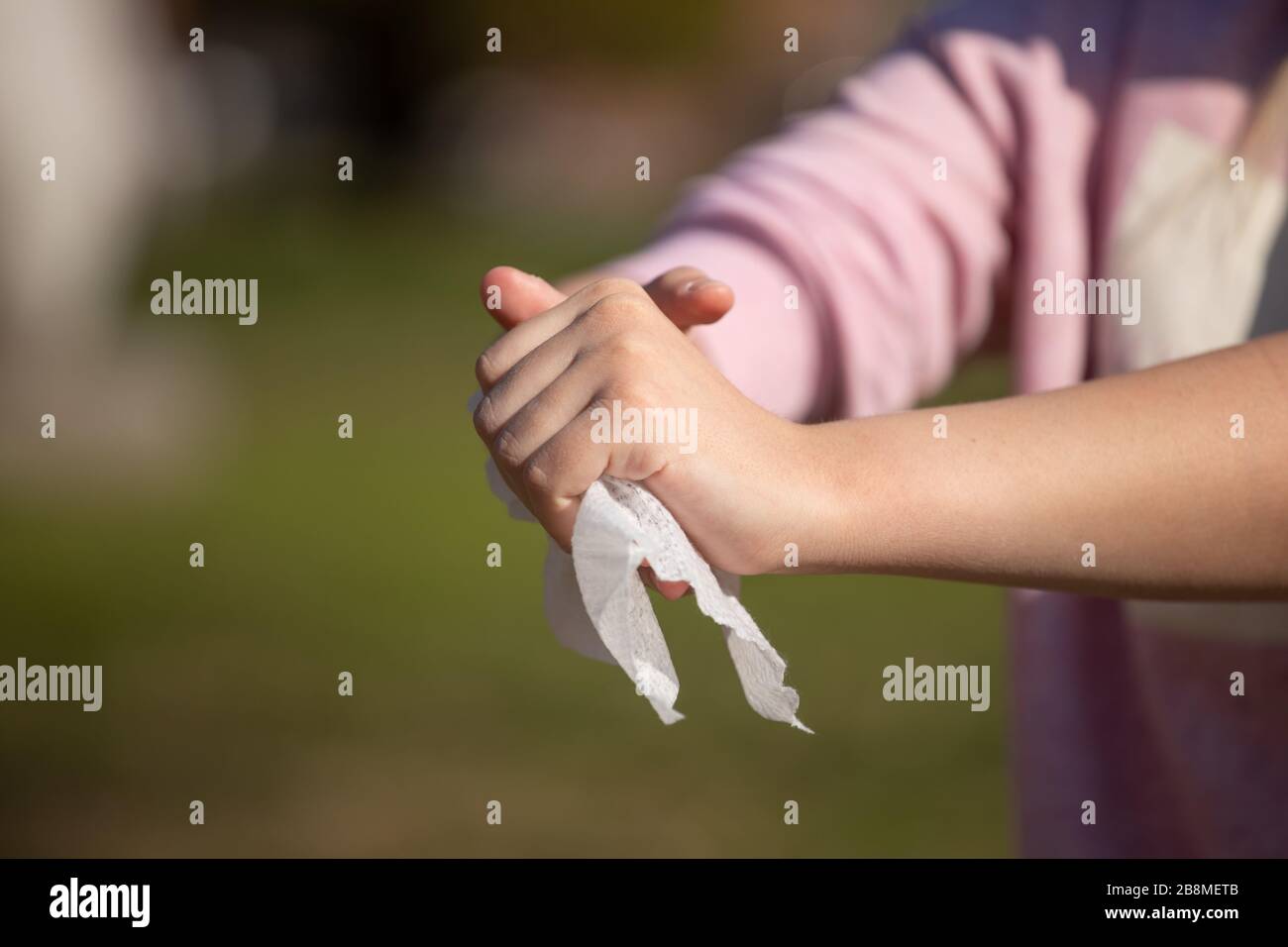 Cleaning hands with wet wipes outdoor against disease infection versus