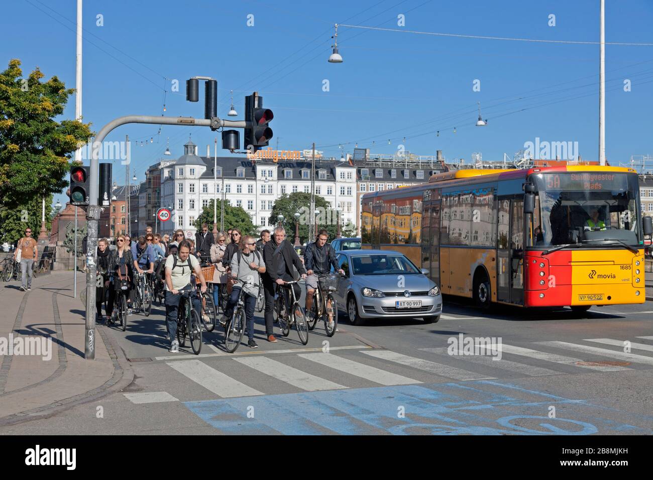 Late morning bicycle rush at red light on bicycle path at heavily bicycle-trafficked crossroads Frederiksborggade Søtorvet, towards central Copenhagen Stock Photo