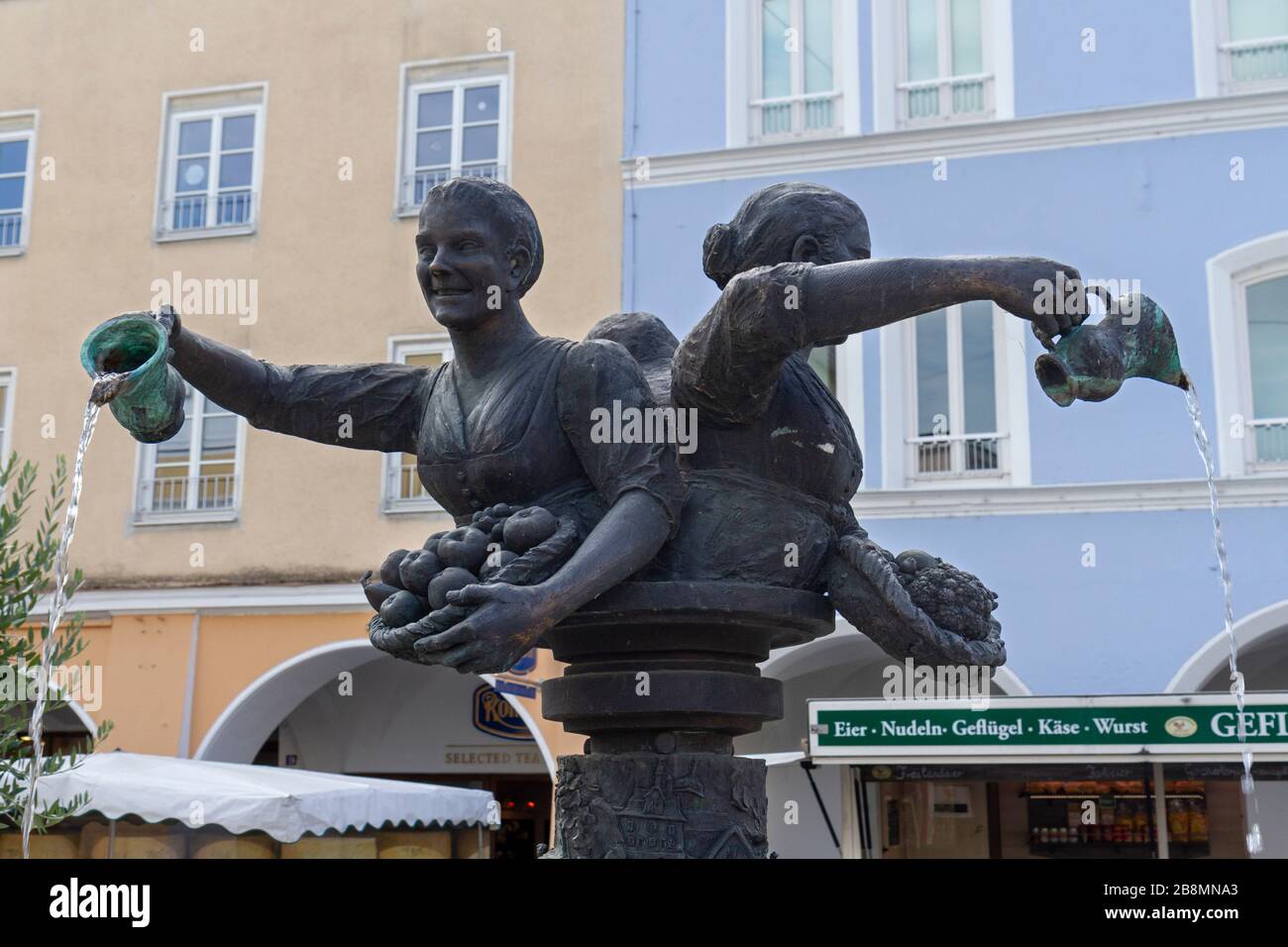 Water fountain with three ladies pouring water in Rosenheim, Bavaria, Germany. Stock Photo