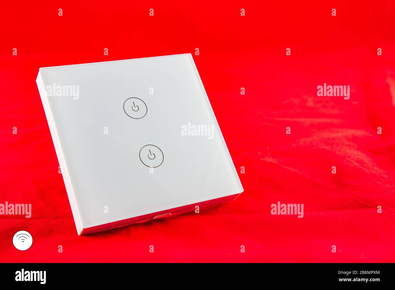 Smart Wi-Fi switch with support for control via mobile  phone application. SHot on red background Stock Photo