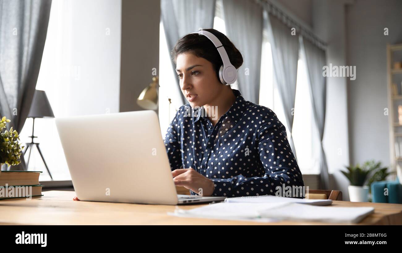 Busy Young Indian Woman Wearing Headphones Working On Laptop Stock 