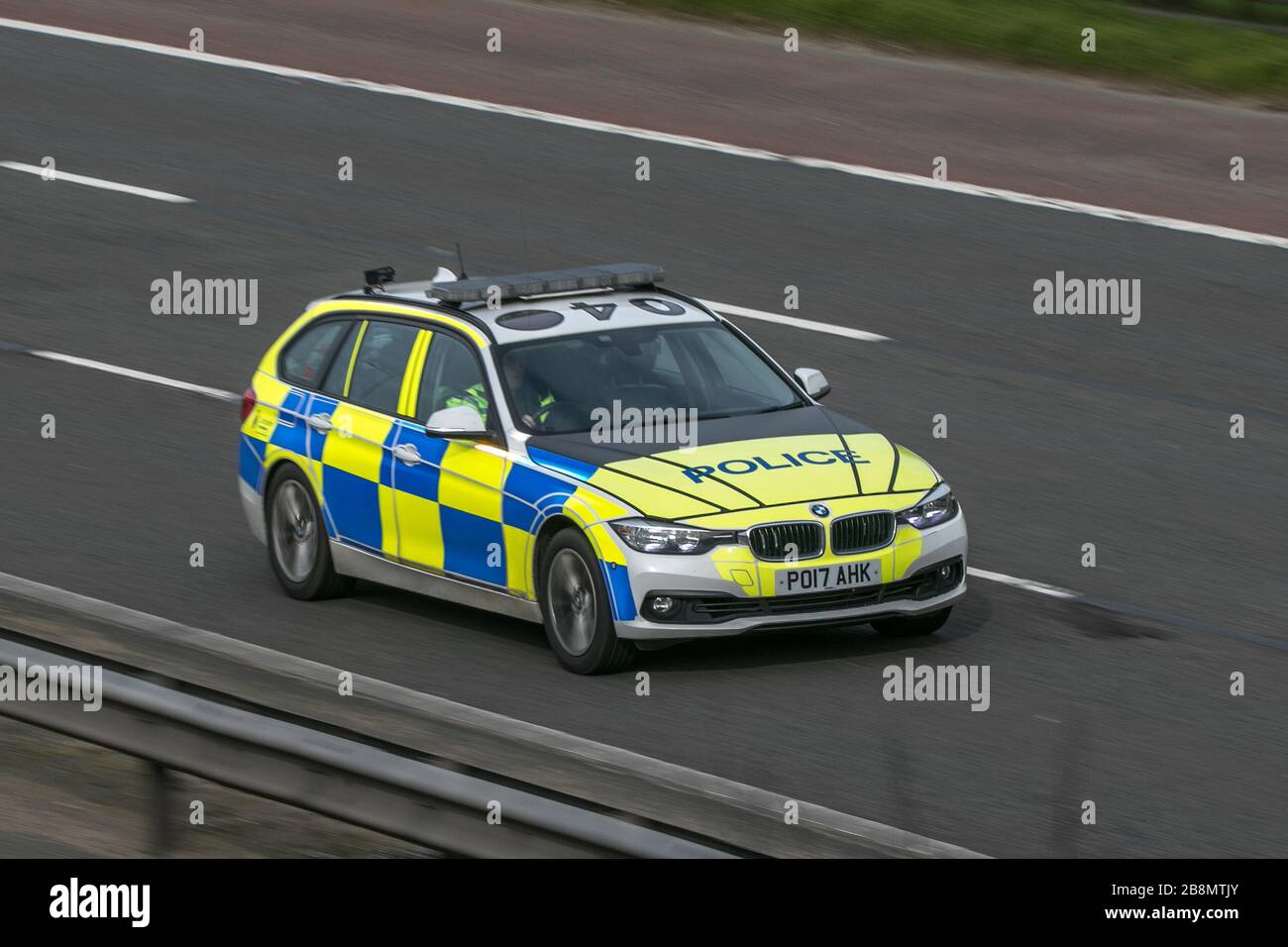 Police car patrolling on the M6 motorway near Preston in Lancashire, UK Stock Photo