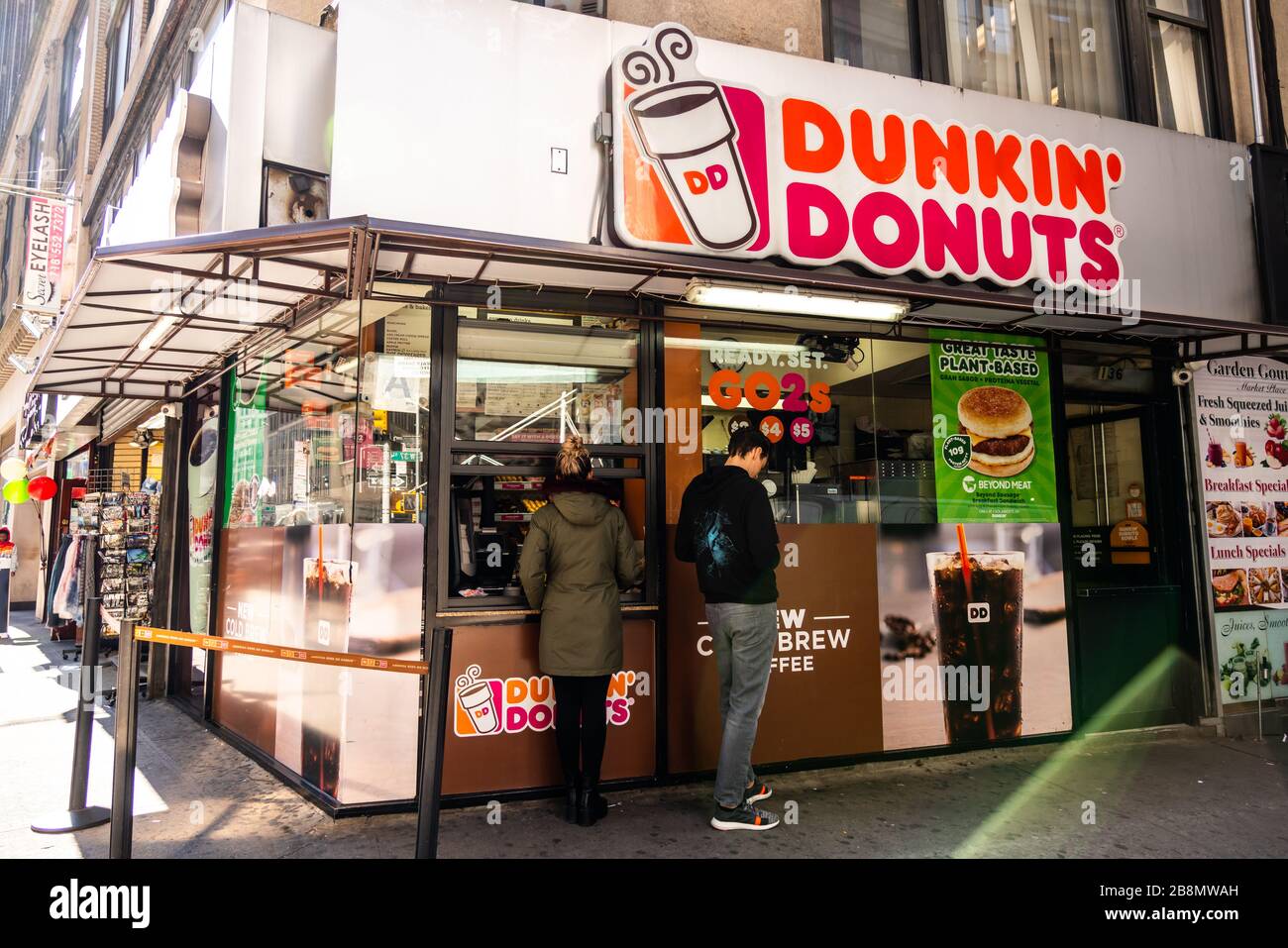 Customers at an American multinational coffeehouse and donut company
