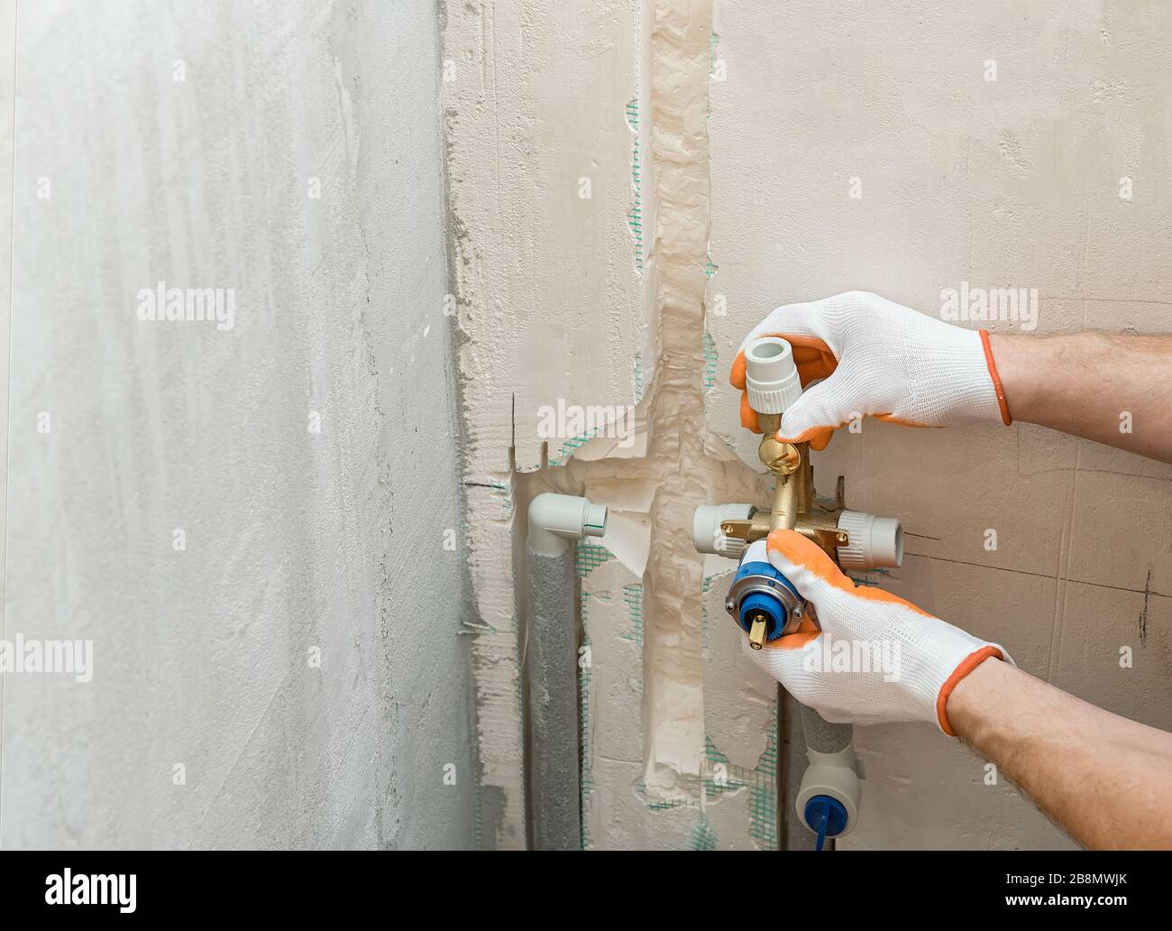 Installation of water pipes in the wall for the builtin shower Stock