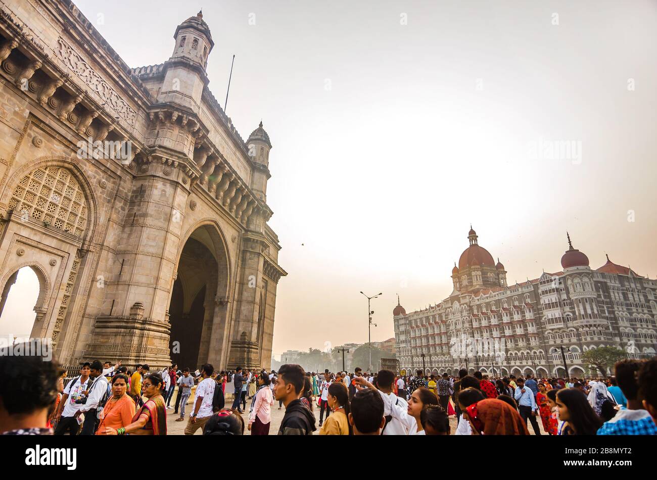 MUMBAI, INDIA – DEC. 8, 2019: Visitors enjoying near Gateway of India, opposite to the prime tourist attraction Taj Mahal Palace and Tower Hotel. Stock Photo