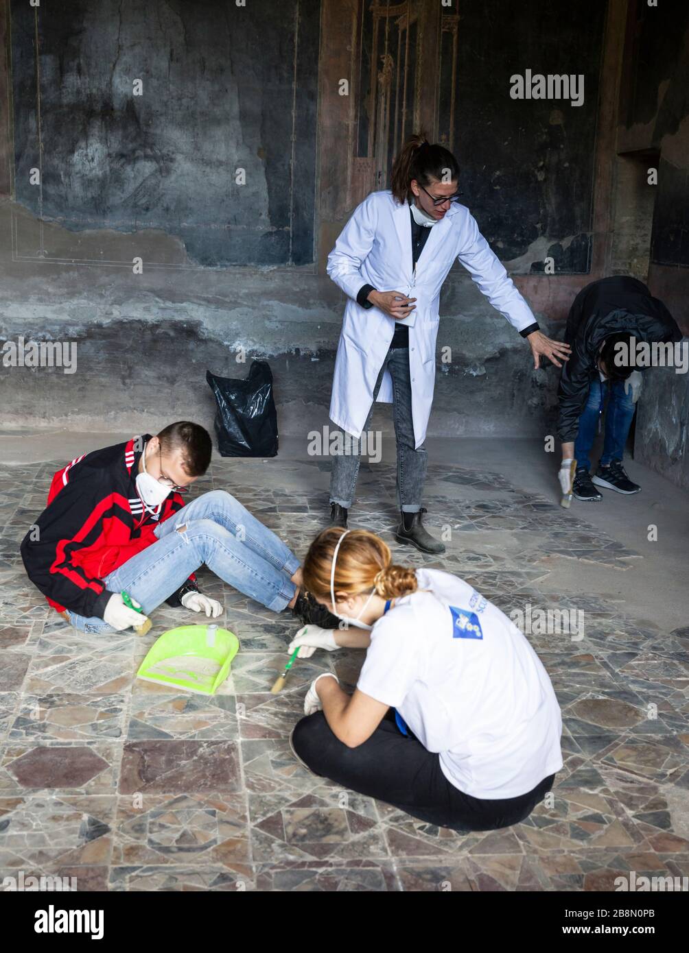 Students working under supervision clearing a floor in the ruins of Herculaneum, Campania, Italy. Stock Photo