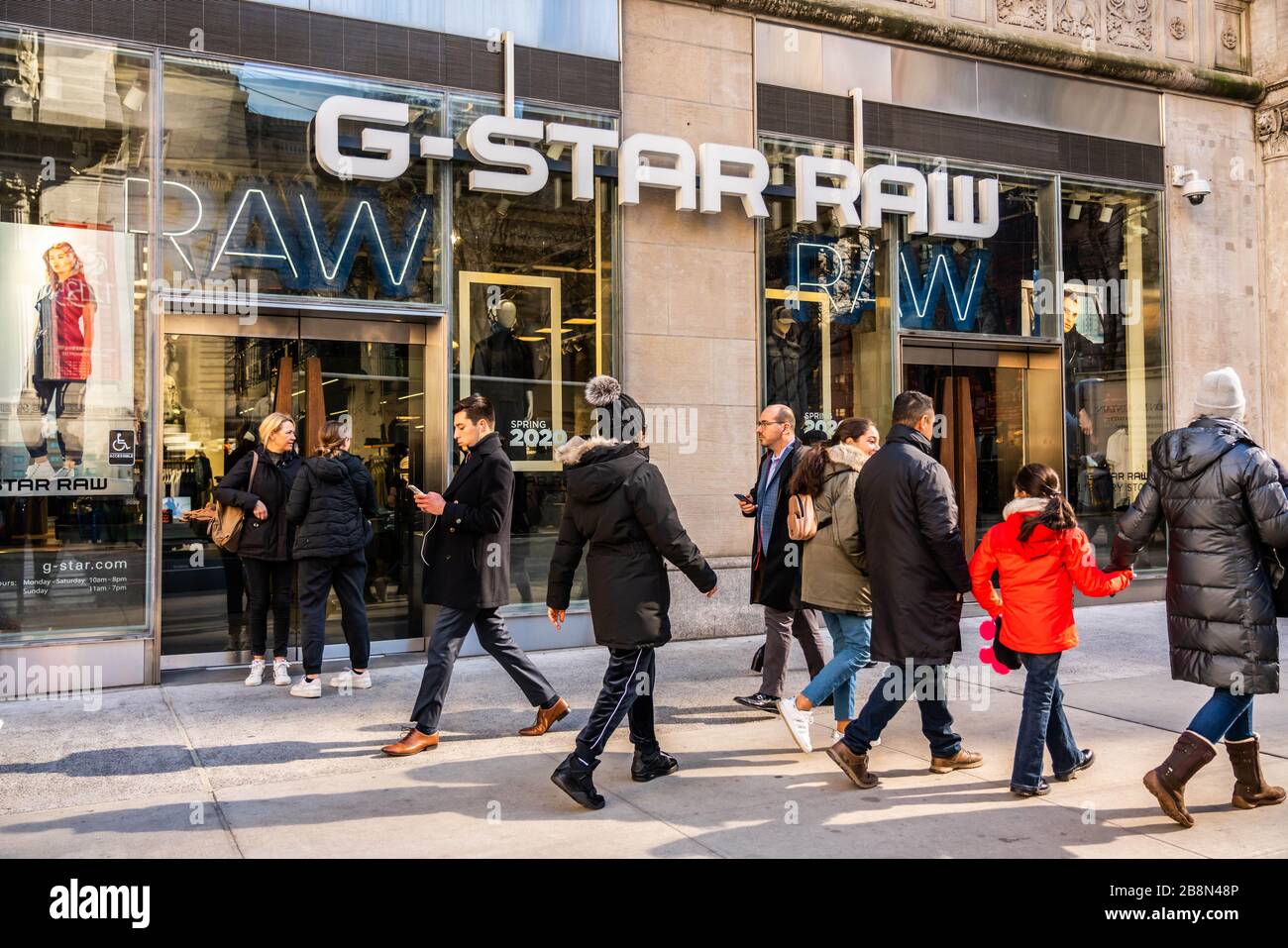 New York City, USA. 20th Feb, 2020. Pedestrians walk past a Dutch designer  clothing company, G-Star RAW store in New York City. Credit: Alex Tai/SOPA  Images/ZUMA Wire/Alamy Live News Stock Photo -