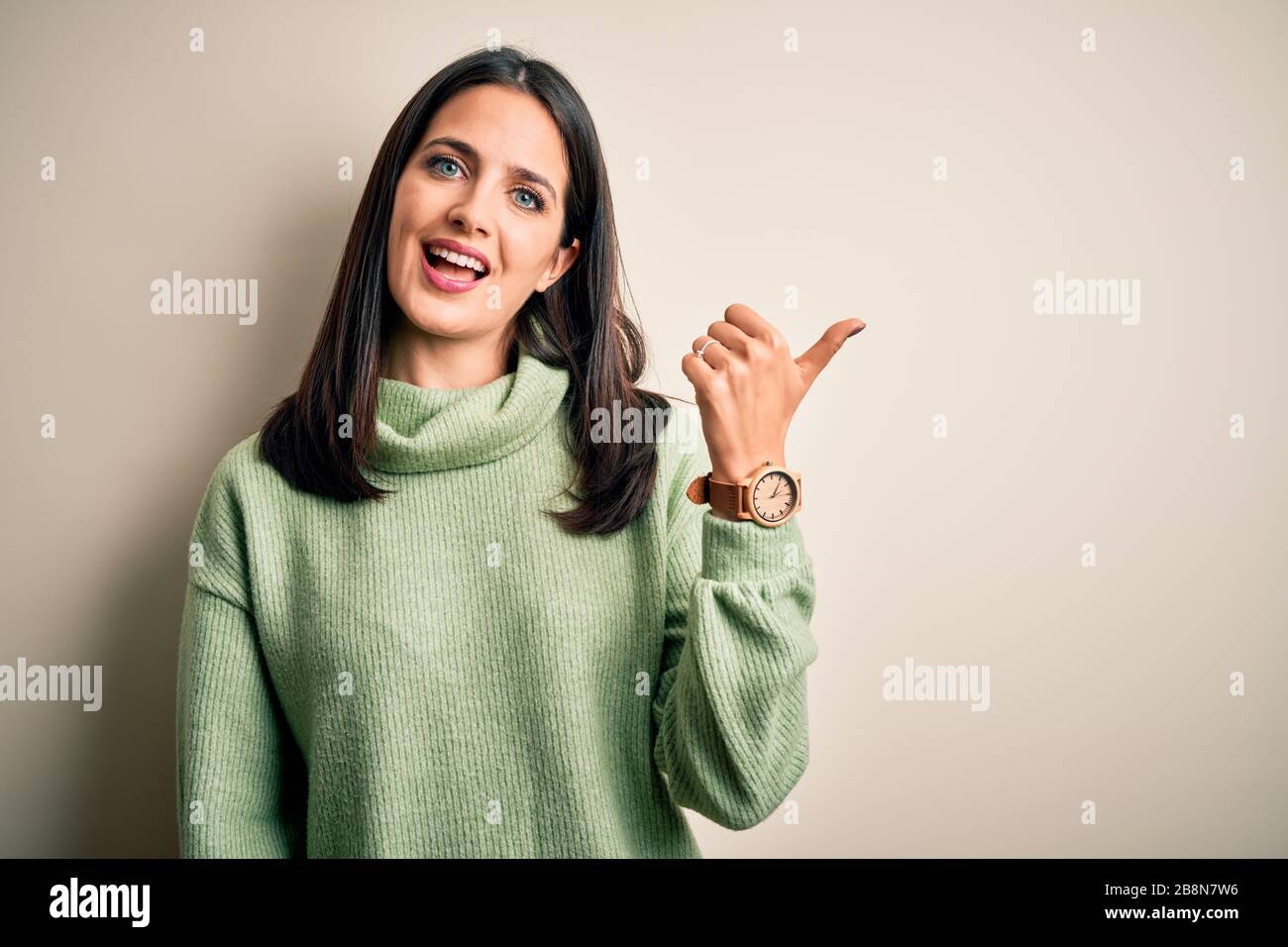 Young brunette woman with blue eyes wearing turtleneck sweater over ...