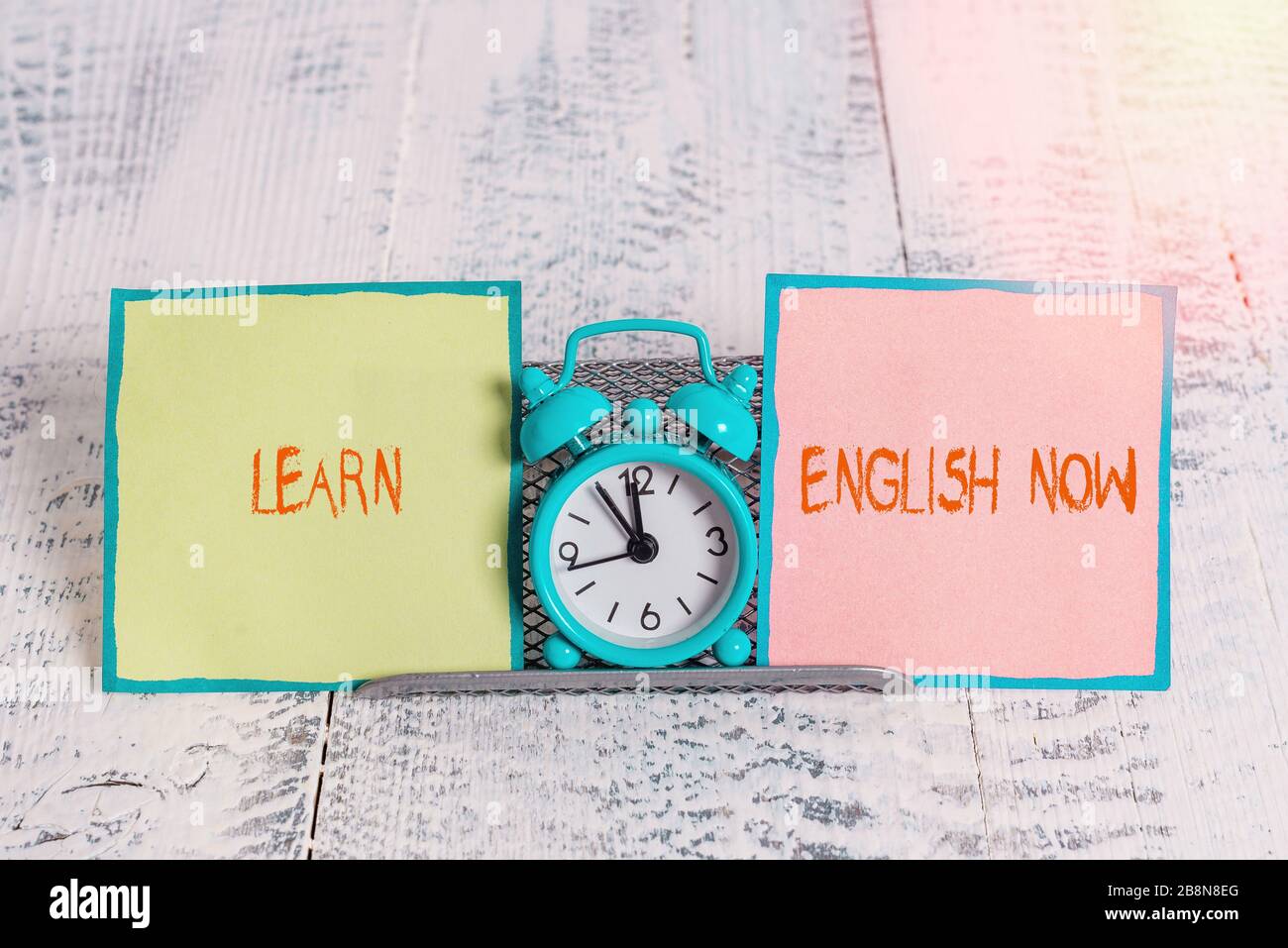 Handwriting text Learn English Now. Conceptual photo gain or acquire  knowledge and skill of english language Mini blue alarm clock standing  above buff Stock Photo - Alamy