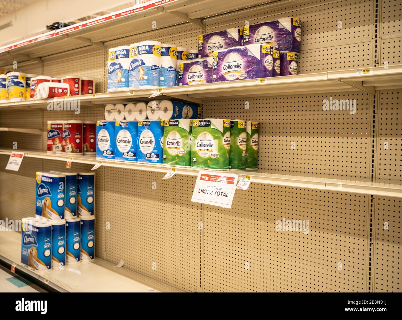 Berks County, Pennsylvania, USA-March 14, 2020: Half empty store shelves with limited supply of toiletpaper Stock Photo