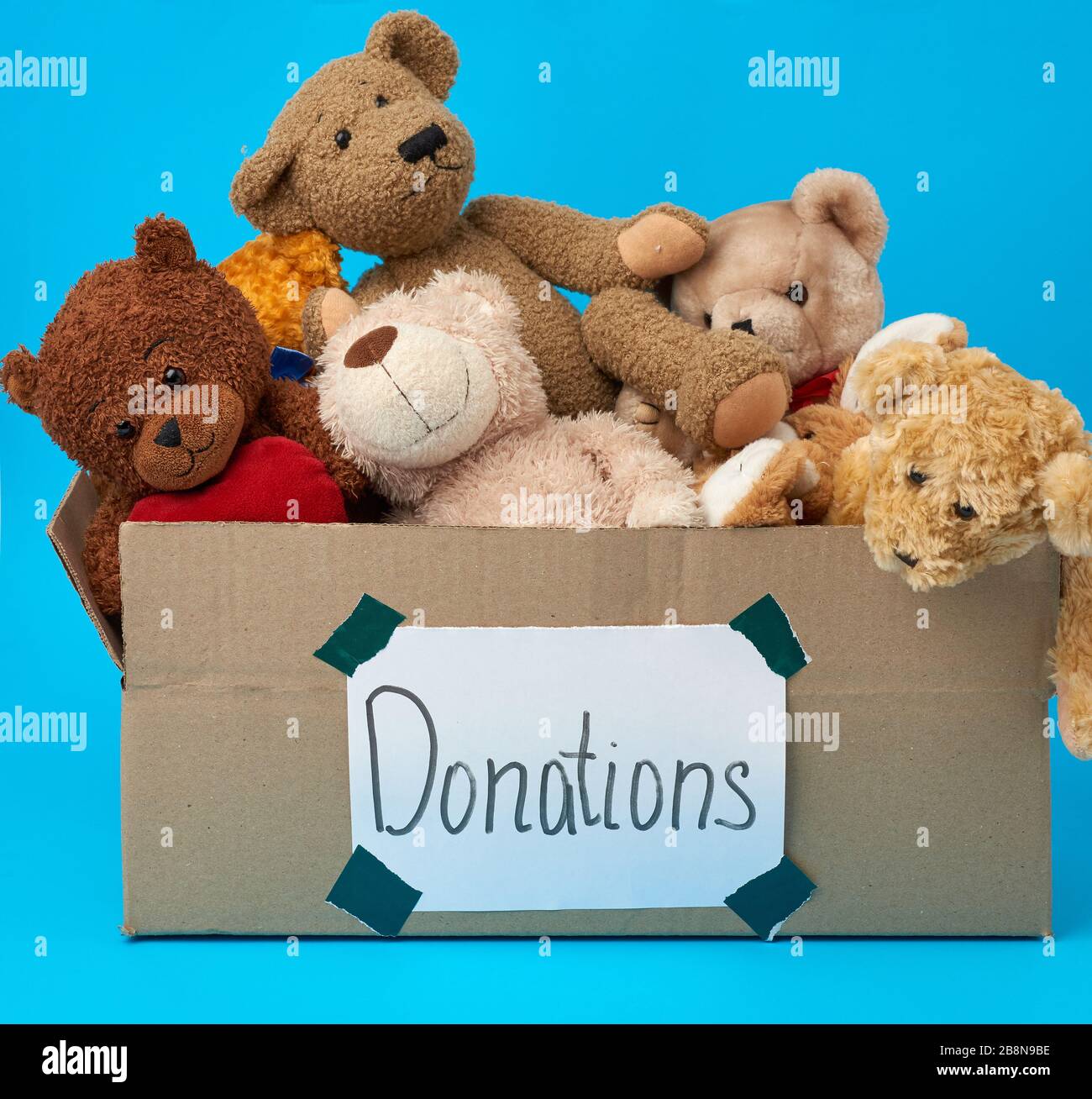 brown cardboard box filled with soft toys,inscription donations on the