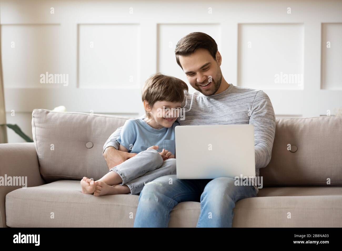 Little boy relax with father using laptop Stock Photo - Alamy