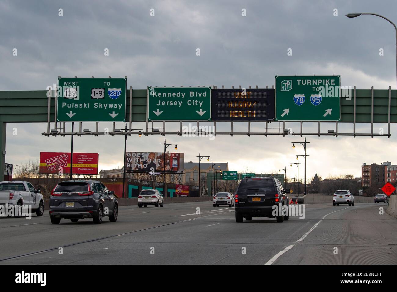 Jersey City, New Jersey, USA. 20th Mar, 2020. NJ Government information notices appear on LED signage as cars drive past in Jersey City, New Jersey. Mandatory credit: Kostas Lymperopoulos/CSM/Alamy Live News Stock Photo