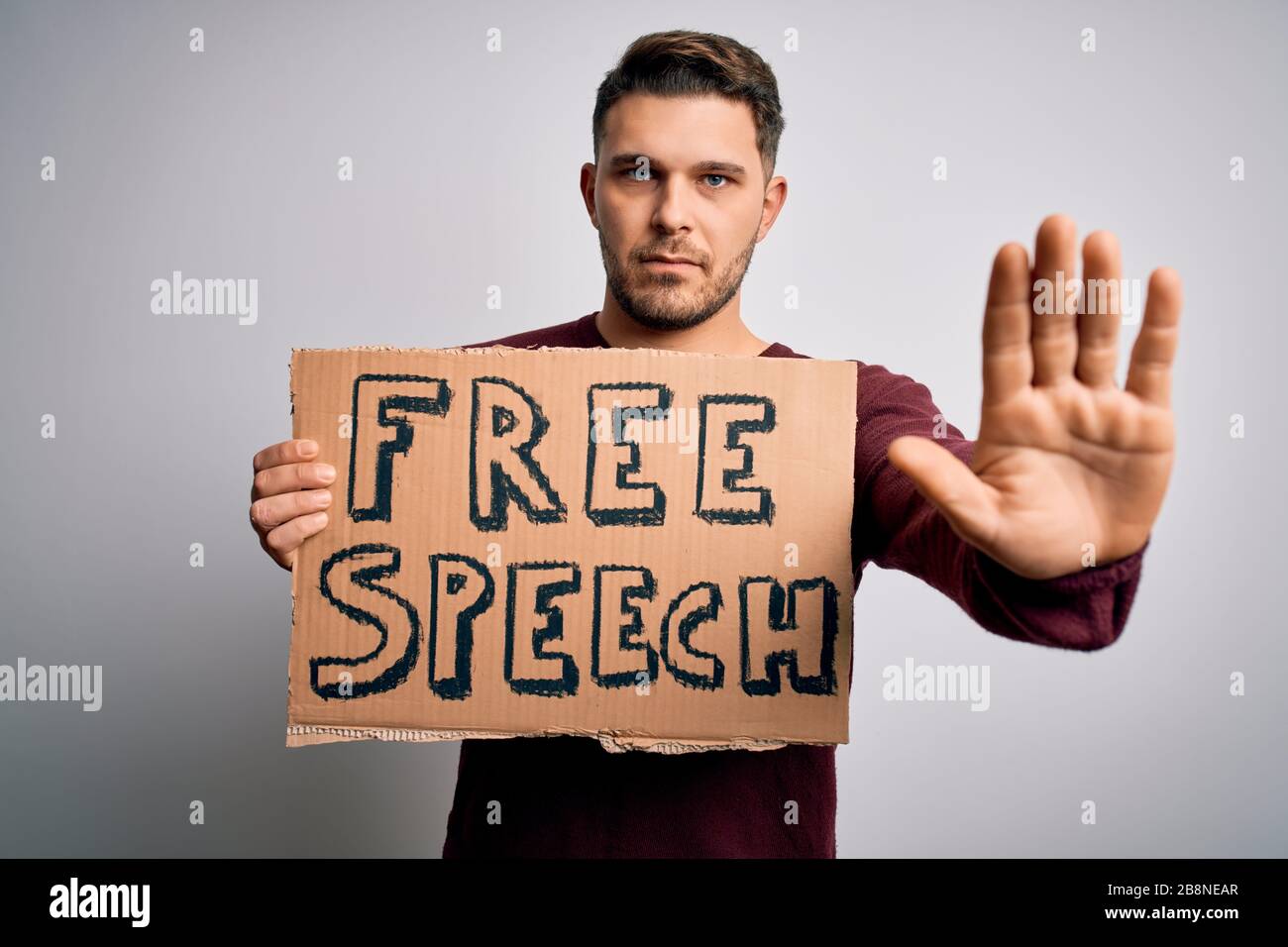 Young man with blue eyes holding banner on protest for free speech ...