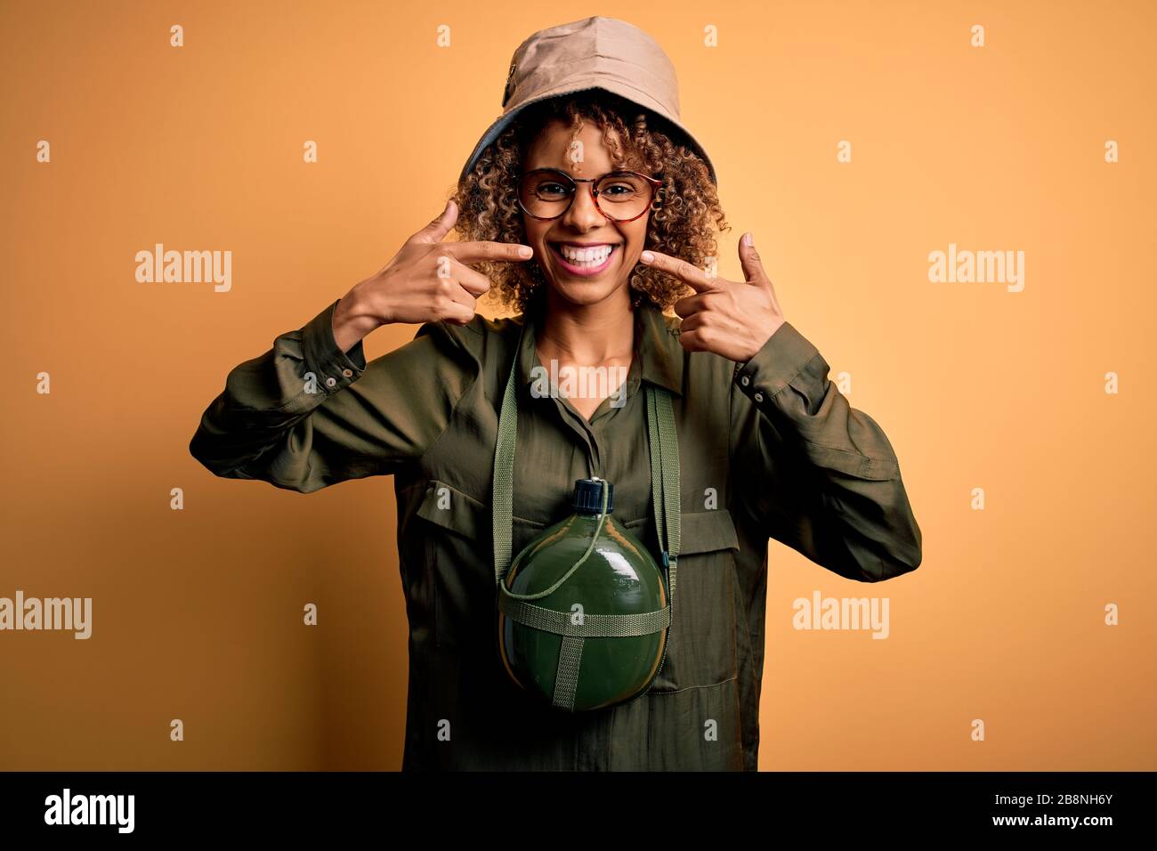 Young african american tourist woman on vacation wearing explorer hat ...
