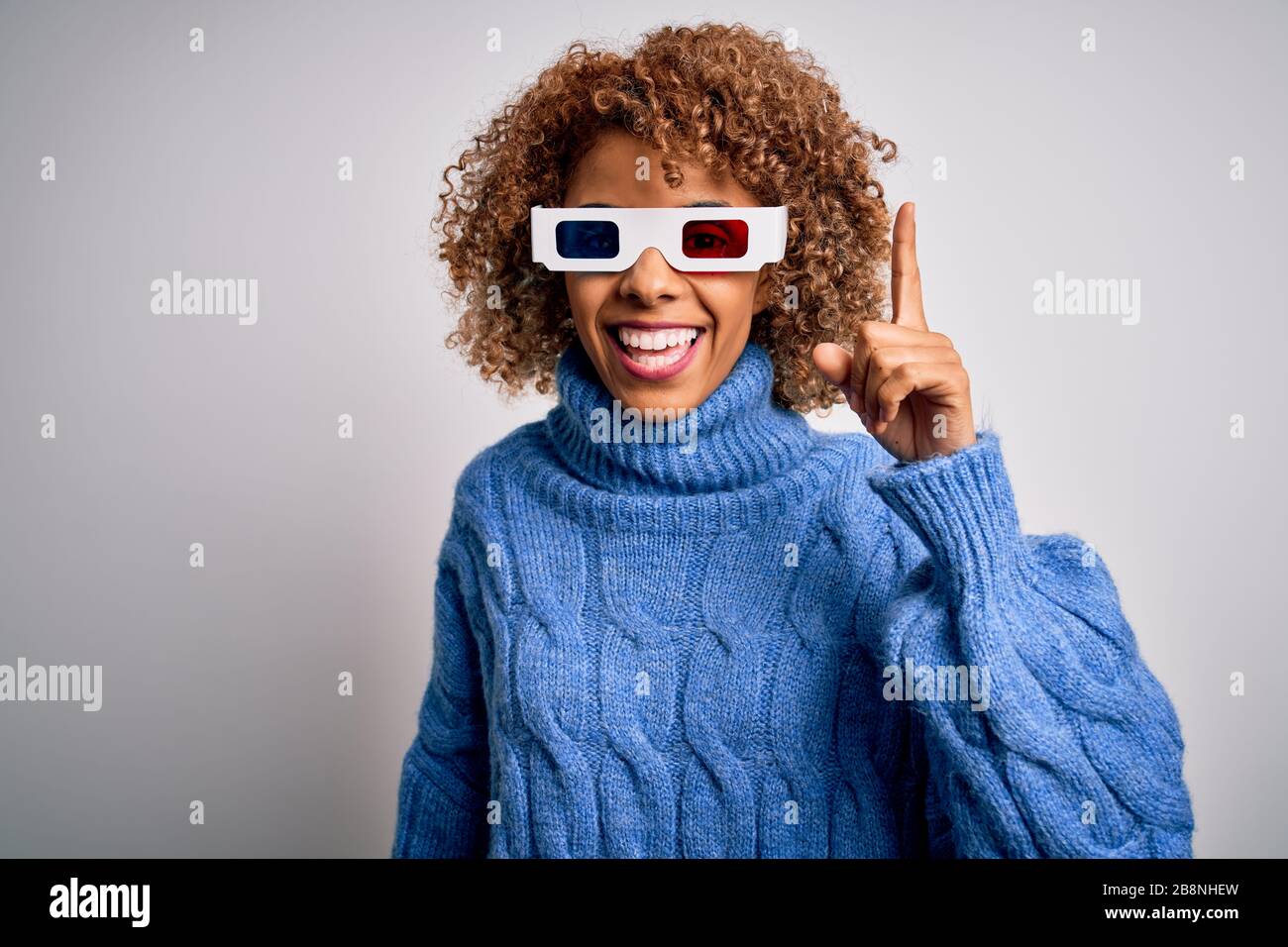 Young african american curly woman wearing 3d glasses over isolated ...