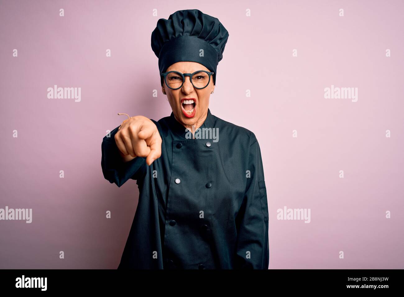 Middle age brunette chef woman wearing cooker uniform and hat over ...