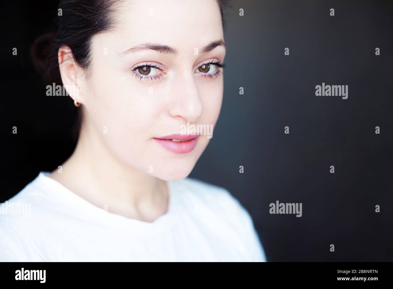Happy girl smiling. Beauty portrait young happy positive brunette woman on black background isolated. European woman headshot. Positive human emotion facial expression body language Stock Photo