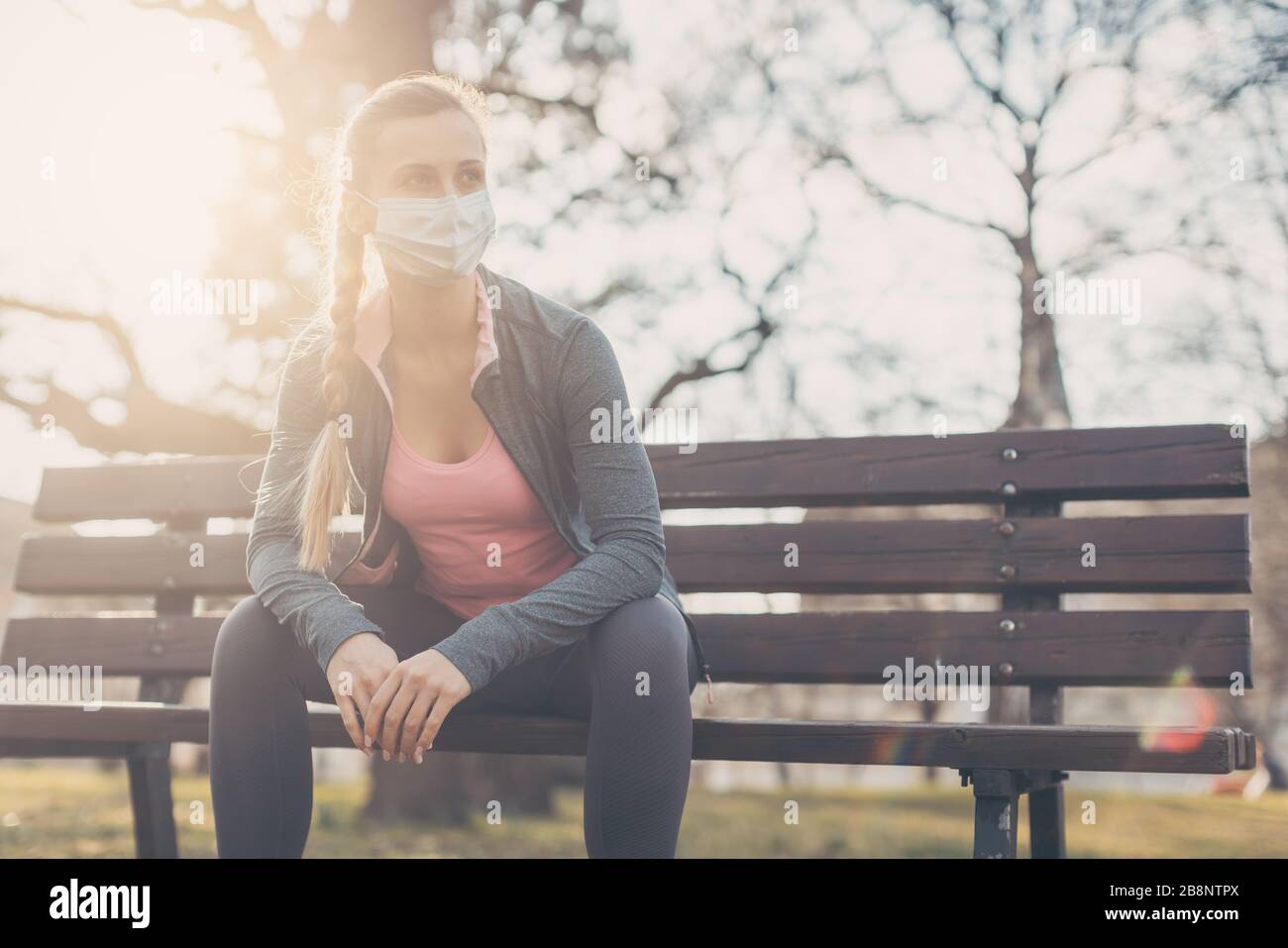 Woman trying to do sport during coronavirus crises despairing of the world Stock Photo