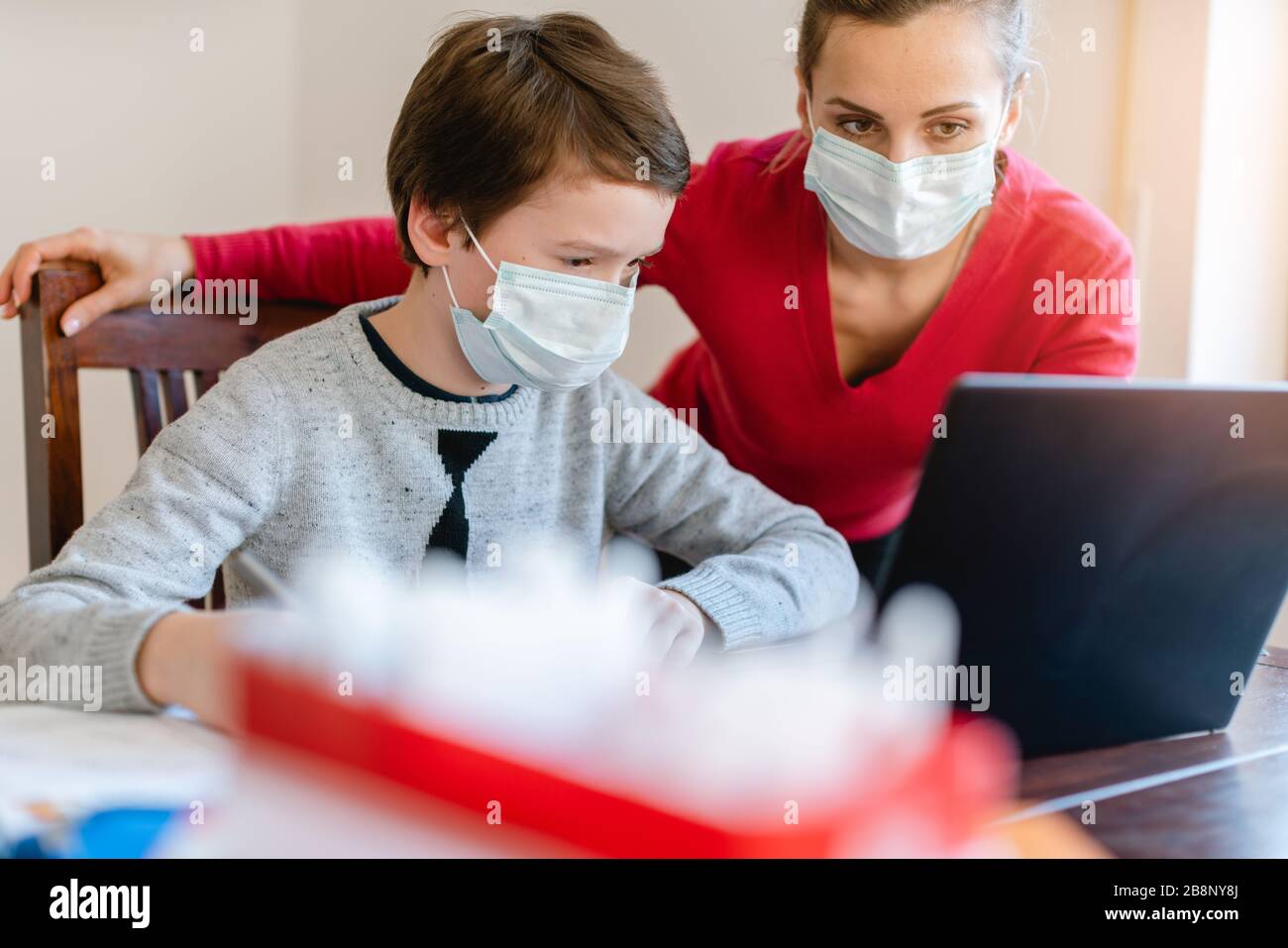 School student learning in video chat with teacher in e-learning Stock Photo