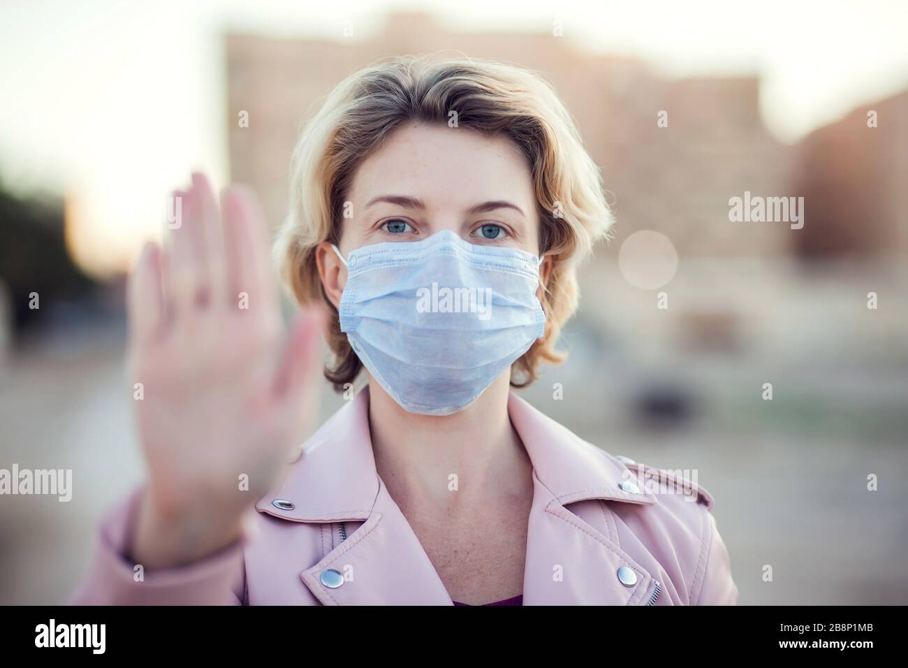 Short Stop Mask A portrait of woman with short blond hair with medical face mask ...