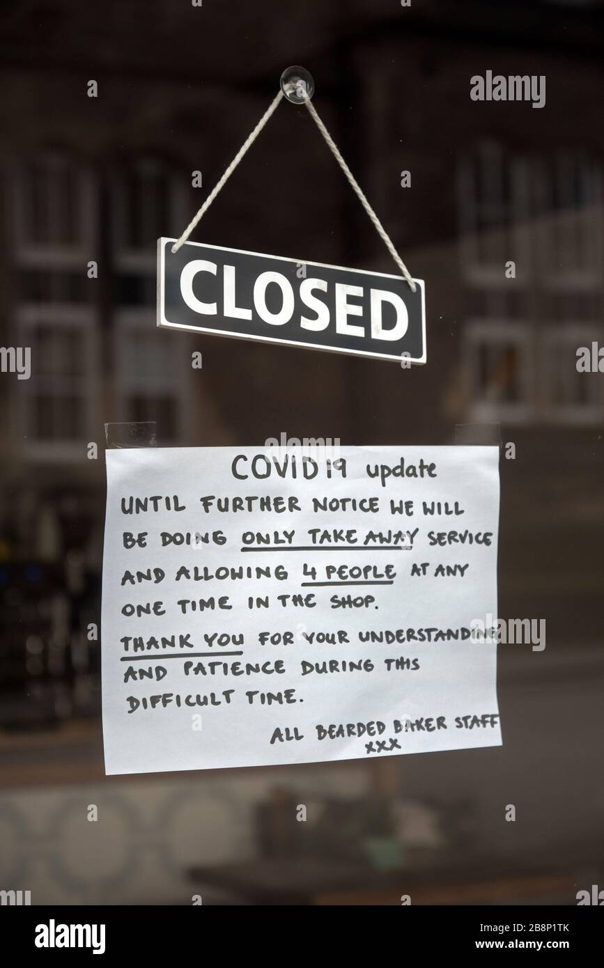 Notice on a small baker's shop in Edinburgh informing customers that the shop is takeaway only due to the Coronavirus. Stock Photo
