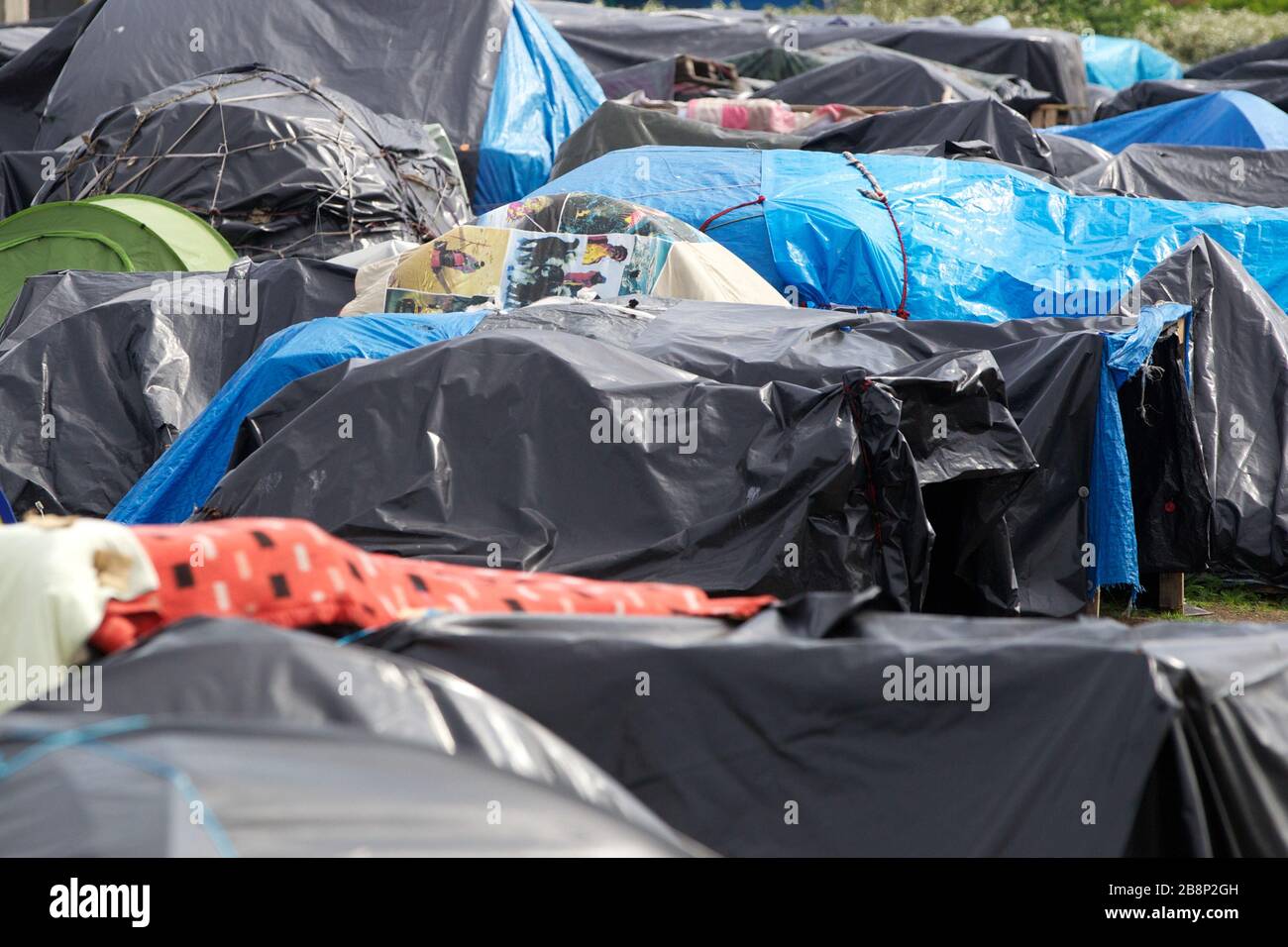 Asylum seekers at the French port of Calais. Everyday hundreds of asylum seekers attempt to stow away inside trucks to allow them to travel illegally Stock Photo
