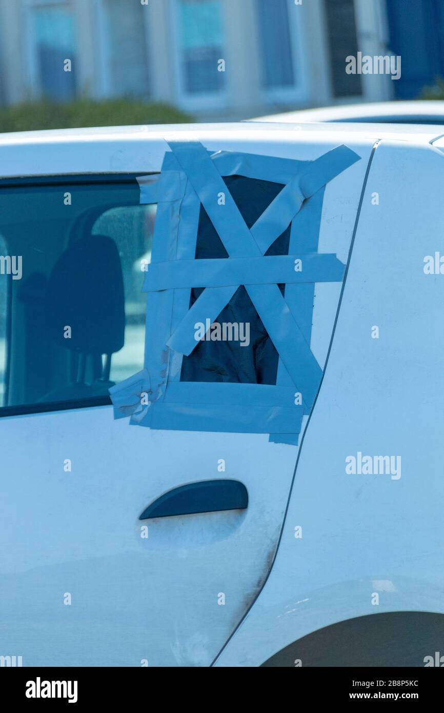 a close up view of a make shift window cover using duct tape and