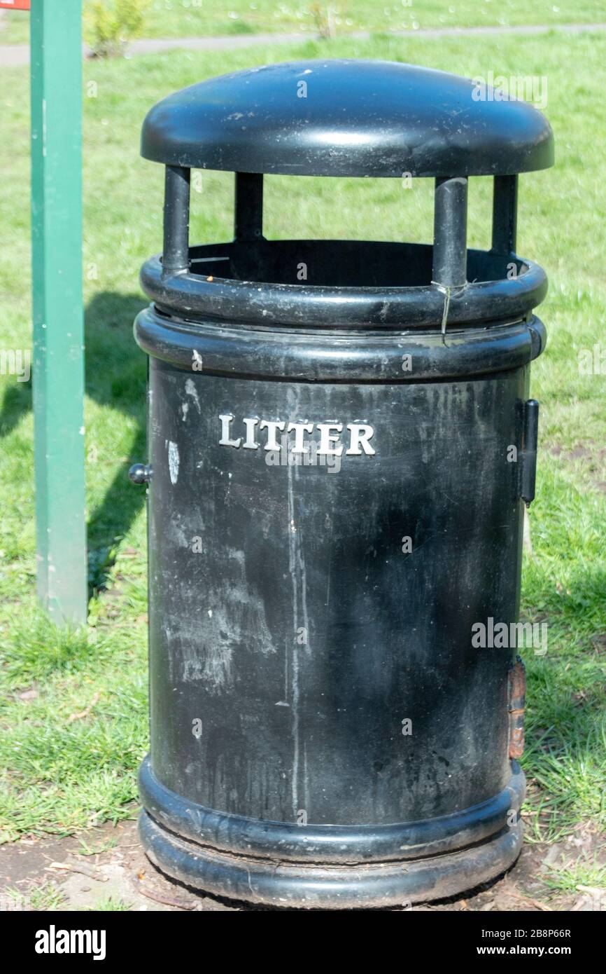 a close up view a black rubbish bin with the word letter litter on the