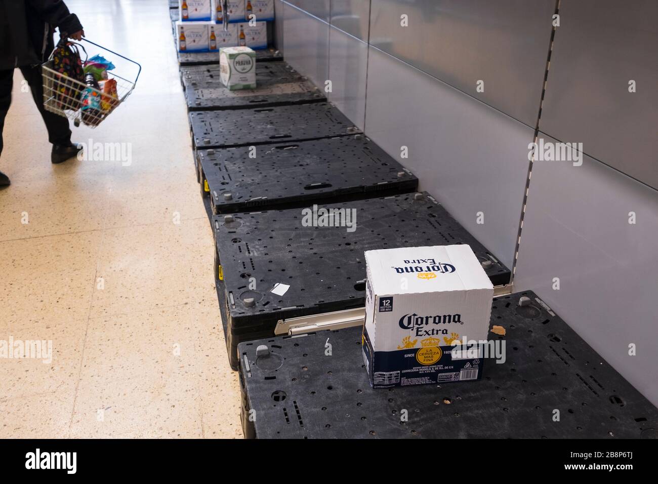 Empty beer shelves in a Tesco supermarket.  During the corona virus panic  shoppers  have bought all the beer except a box of Corona beer! Stock Photo