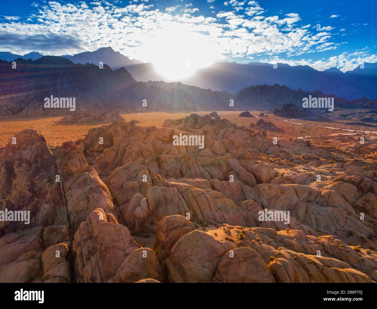 Aerial view of the rock formations of the Alabama Hills with Mt. Whitney and the Sierra Nevada Mountains in the distance. Stock Photo