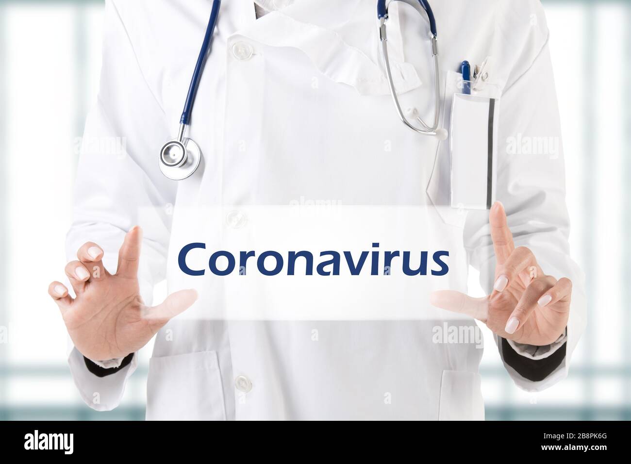 Female doctor holding card with the word coronavirus Stock Photo