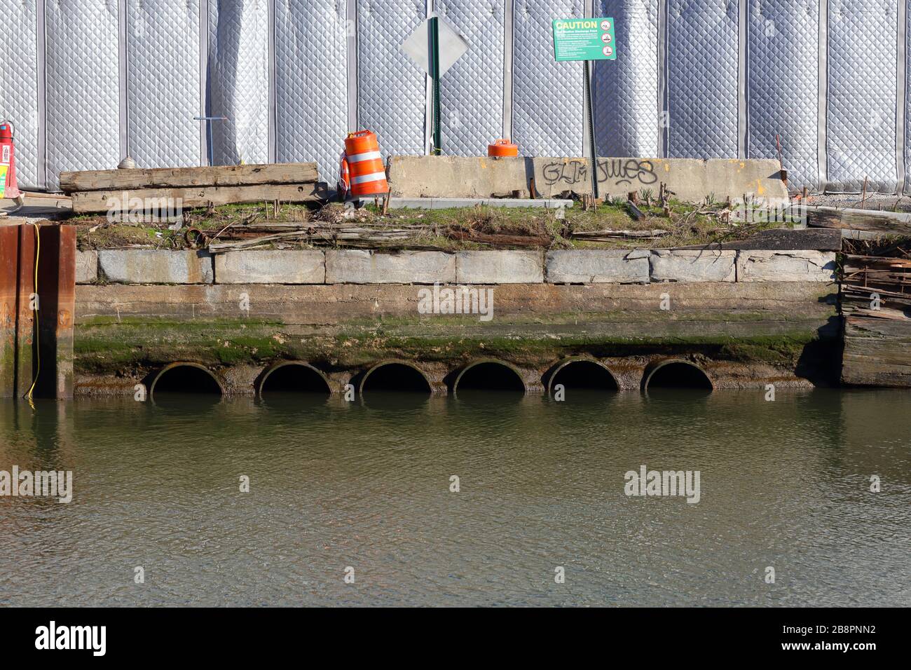 Drainage pipes of a wet weather discharge point in the Gowanus Canal. Stormwater can overwhelm the sewer system resulting in combined sewer overflows. Stock Photo