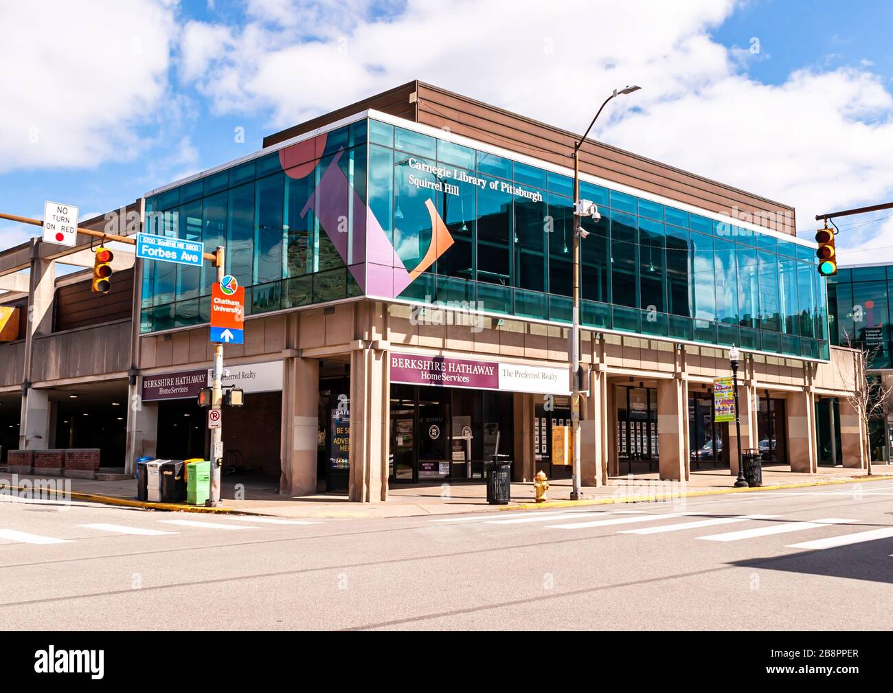The Squirrel Hill Carnegie Library on the corner of Forbes and Murray Avenues with a real estate