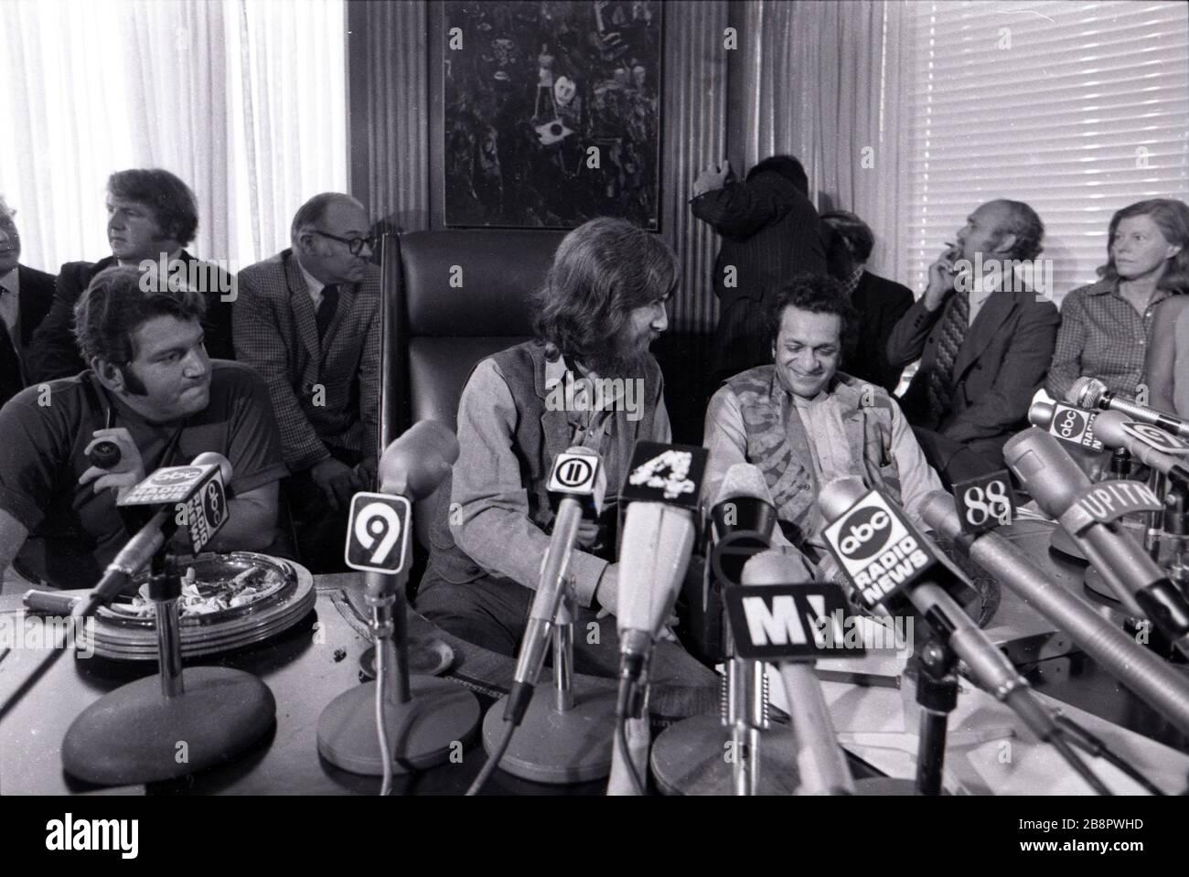 Beatles' guitarist George Harrison and sitar legend Ravi Shankar hold a press conference announcing their beneift concert and album to aid victims of famine and war in Bangladesh, known as 'The Concert for Bangladesh.'  The event is held at Allen Klein's ABKCO offices in midtown Manhattan on July 27, 1971 in New York, NY.  Credit: Rock Negatives / MediaPunch Stock Photo